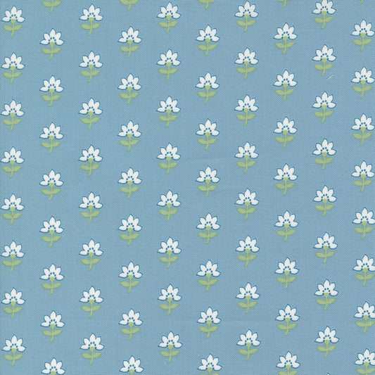Fabric, Shoreline Camille Roskelley. White floral pattern with blue background.