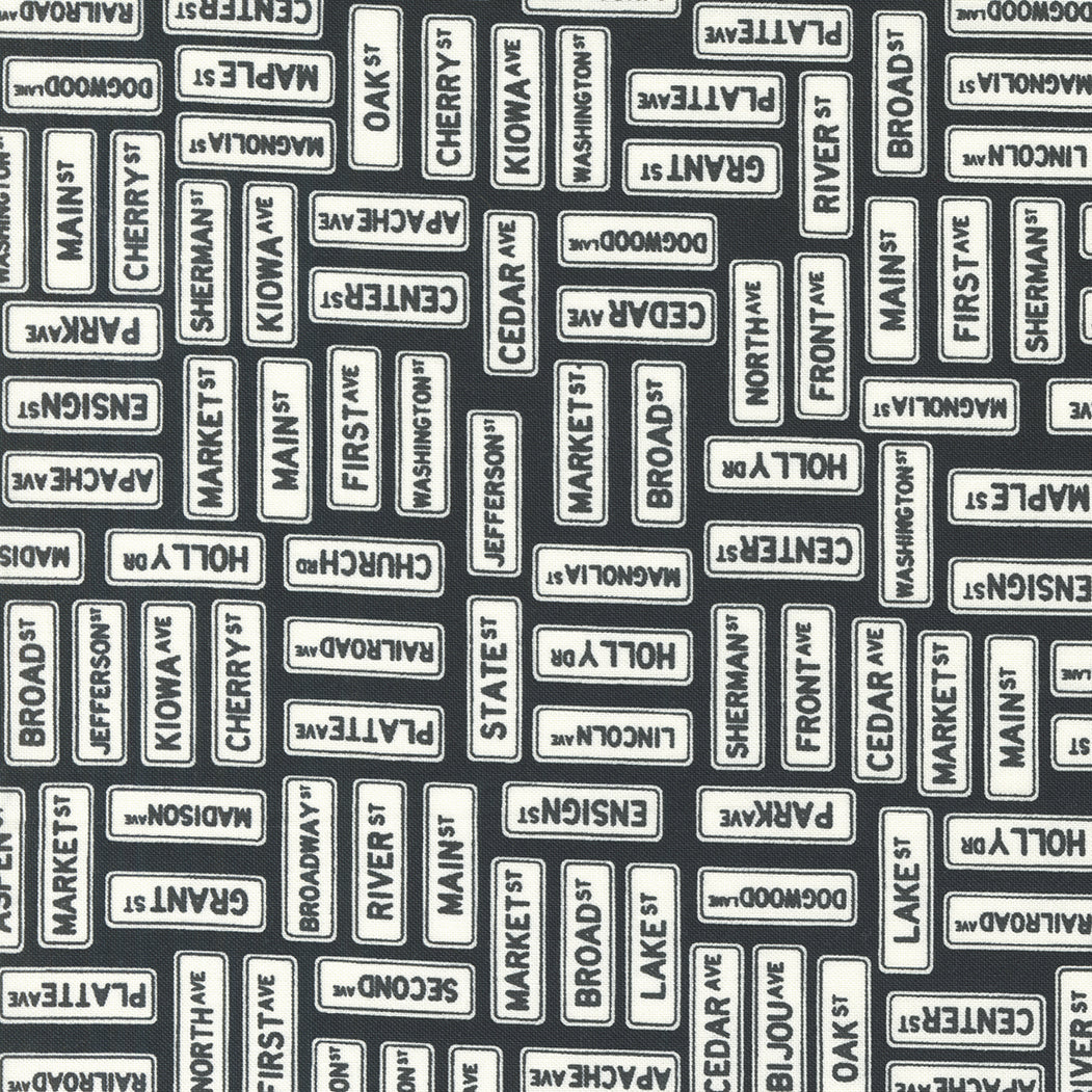 Main Street Street Signs Black M5564325 by Sweetwater for Moda Fabrics (sold in 25cm increments)